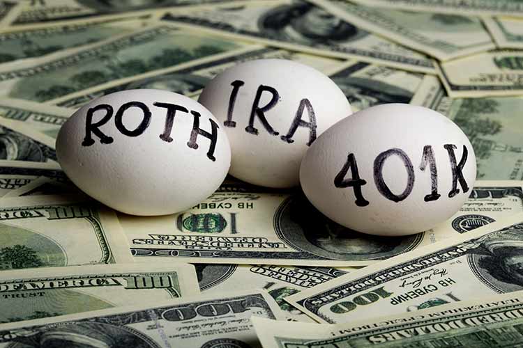 Roth, IRA, and 401k eggs on stack of money